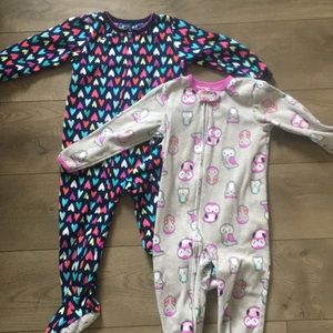 Two fleece carters girls footie pajamas.